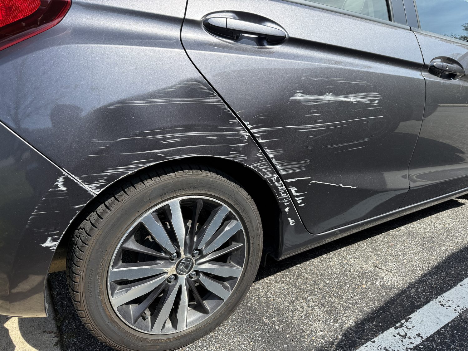 Gray Honda rear door and quarter panel with white scrape marks