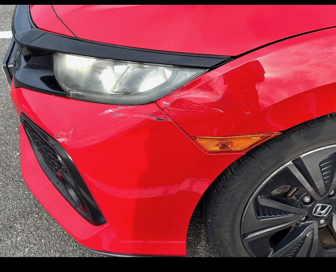 Red Civic front corner before repair with visible white scrape damage